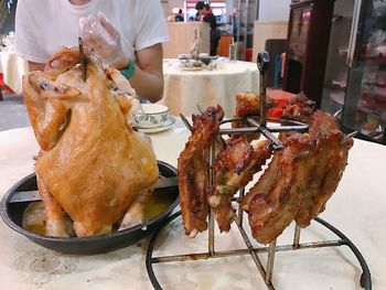 Midsection of man preparing food in plate