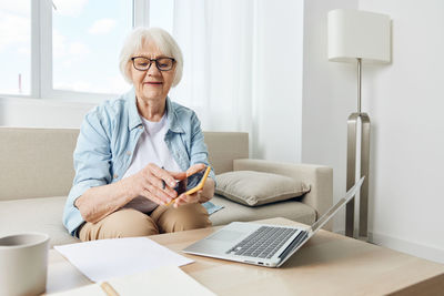 Young woman using laptop at table