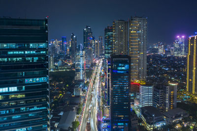 Aerial view of buildings in city against sky