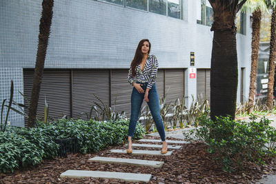 Woman standing against wall