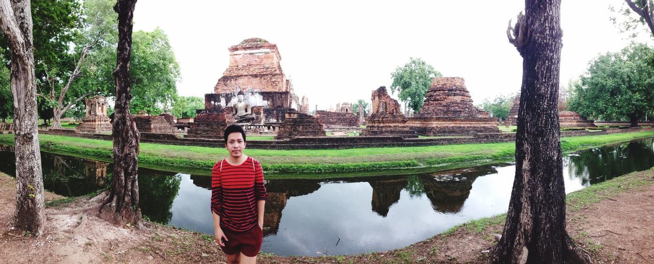 lifestyles, temple - building, built structure, spirituality, leisure activity, tree, cultures, famous place, tourism, travel destinations, temple, history, tourist, sky, unrecognizable person, outdoors, day, culture, casual clothing, ancient, vacations, nature