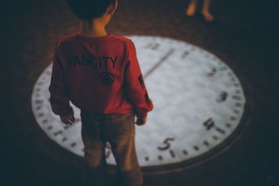 Rear view of boy standing with text