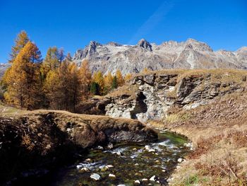 Scenic view of mountains against clear blue sky