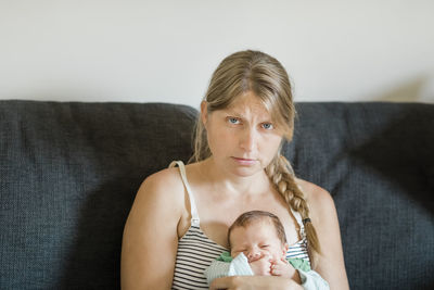 Portrait of mother and son on sofa