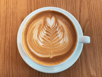 Directly above shot of cappuccino served on table