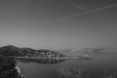 Scenic view of lake by mountains against sky