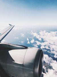 Close-up of airplane wing against sky