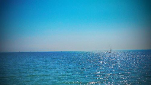 Scenic view of sea against clear blue sky