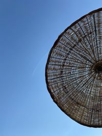 Low angle view of metallic structure against clear blue sky