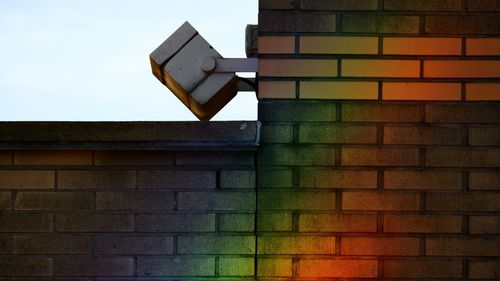 Low angle view of basketball hoop against brick wall