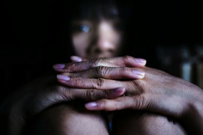 Close-up of woman in dark