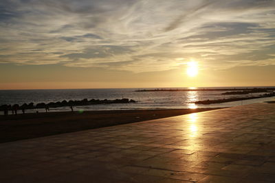 Scenic view of beach against sky during sunset