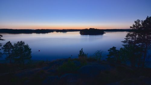 Scenic view of lake against sky at sunset