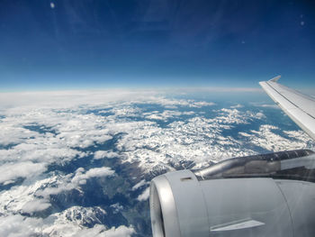 Aerial view of cloudscape over airplane wing