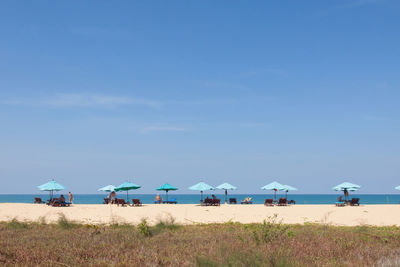 Scenic view of beach against blue sky