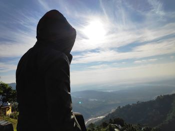 Man standing on mountain against sky