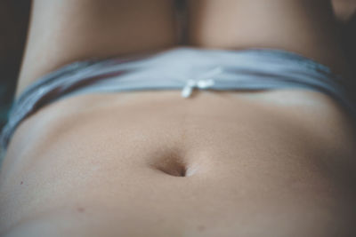 Close-up of woman lying down on floor