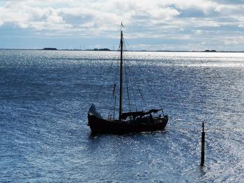Sailboat in sea against sky