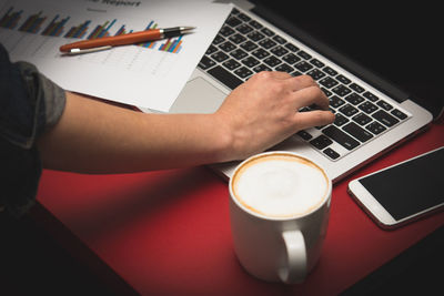 Financial report with chart and data on a laptop with business woman's hands at work