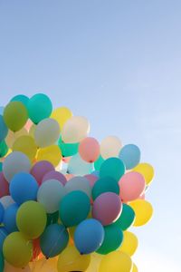 Low angle view of balloons against sky