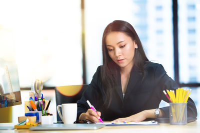 Businesswoman working at desk in office