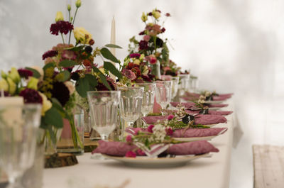 Plates and glasses arranged on dining table