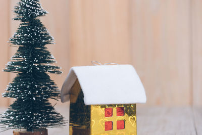 Close-up of christmas decoration on table against wall
