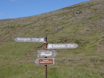 Information sign on landscape against the sky