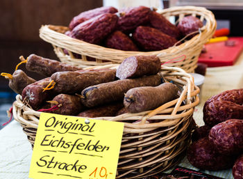 Close-up of sausages for sale in market with price tag