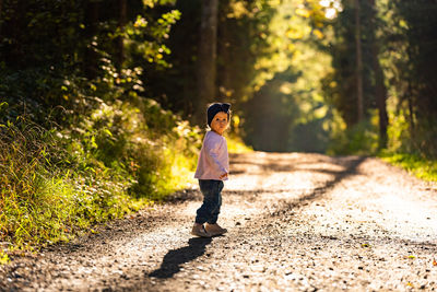 Portrait of girl standing on road