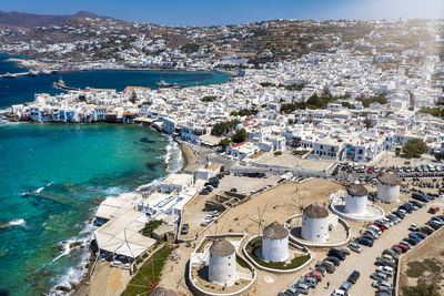 High angle view of townscape by sea against sky