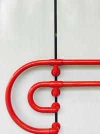 Close-up of red metal against white background