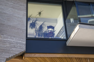 Low angle view of building seen through window