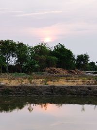 Scenic view of lake against sky during sunset