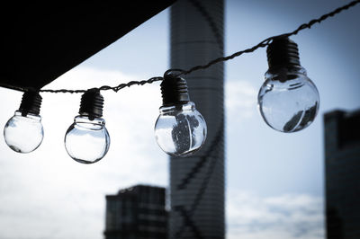 Low angle view of light bulb against sky