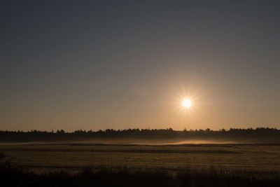 Scenic view of field against sky during sunset