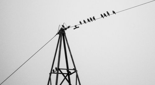 Low angle view of crane against clear sky