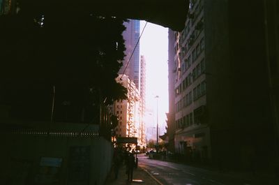 City street amidst buildings against sky at night