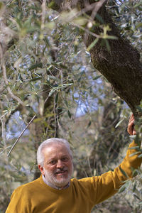 Portrait of man with tree in background