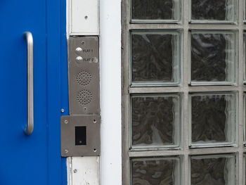 Blue metal block door, intercom and glass block window