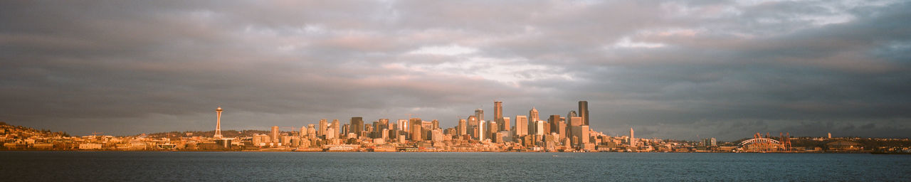 Panoramic view of sea and buildings against sky