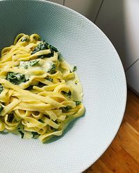 Tagliatelle pasta,  long ribbon pasta with spinach and cheese sauce, italian plate with pasta