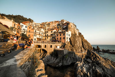 Houses on rock formation at manarola against clear sky