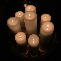 Close-up of illuminated tea light candles on table