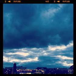 Buildings against cloudy sky