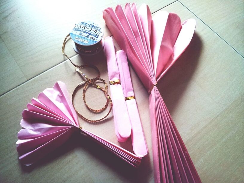 indoors, high angle view, table, still life, close-up, multi colored, no people, pink color, wood - material, purple, flooring, directly above, hardwood floor, art and craft, absence, wall - building feature, creativity, home interior, single object, red