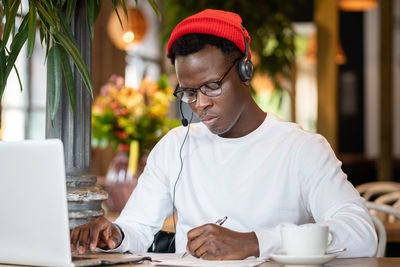 Young man studying in cafe