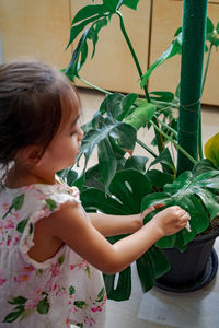 Midsection of woman with potted plants