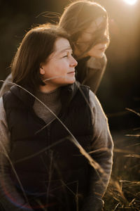 Close-up of happy mother and daughter during sunset.