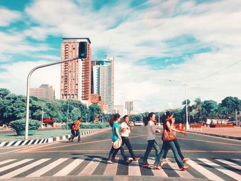 People walking on road in city